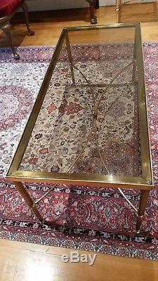 A set of vintage brass and smoked glass coffee tables